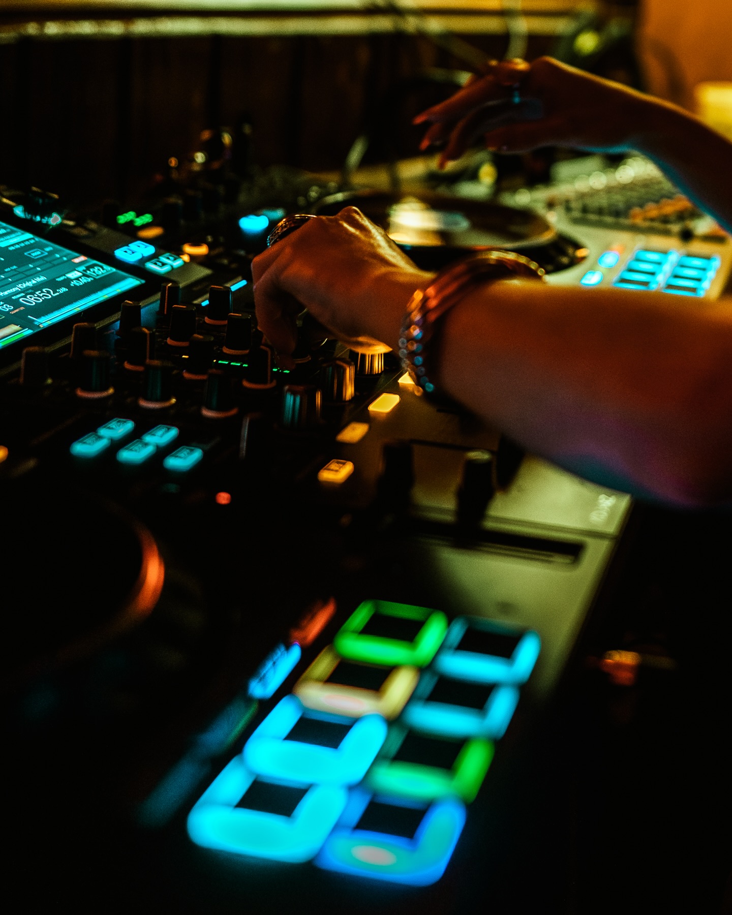 Close-up of glowing DJ decks during a live set at Sip Haus Austin