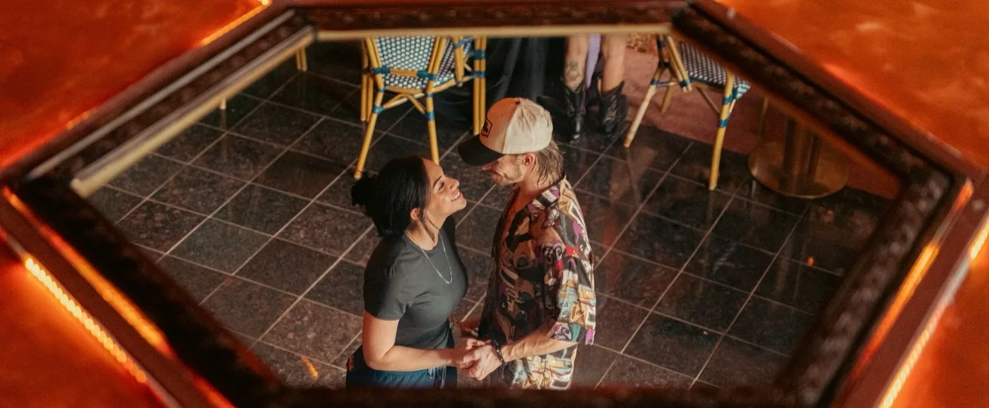 Couple dancing, seen in an overhead mirror at Sip Haus