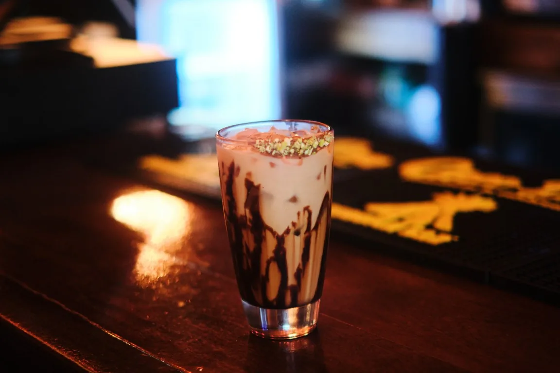 Iced latte with chocolate drizzle and crushed pistachio at the Sip Haus bar