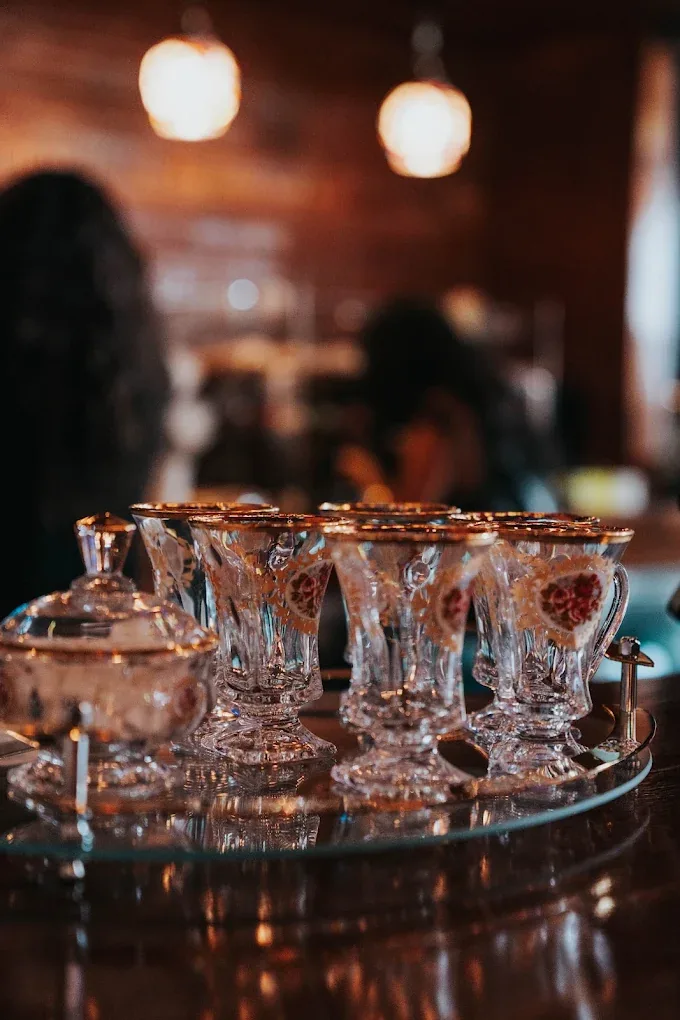 Gold-rimmed Persian tea glasses on a tray at Sip Haus