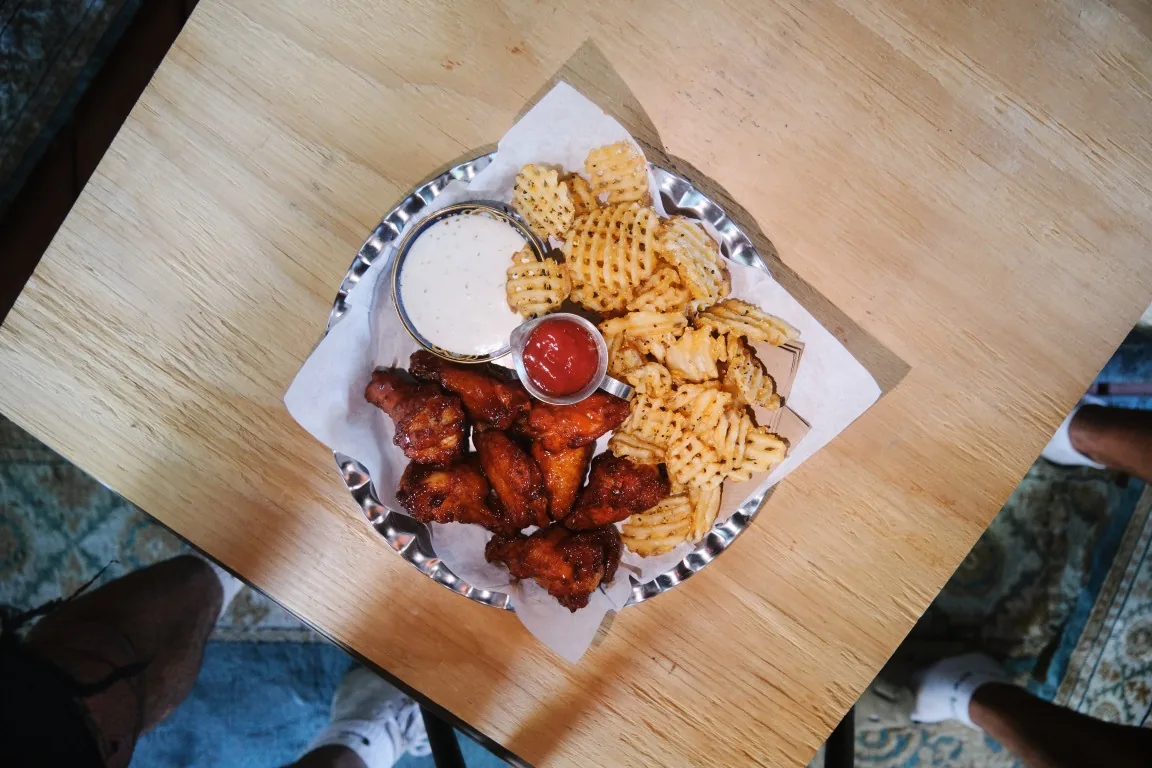 Overhead view of Sip Haus wings with waffle fries, ranch and ketchup
